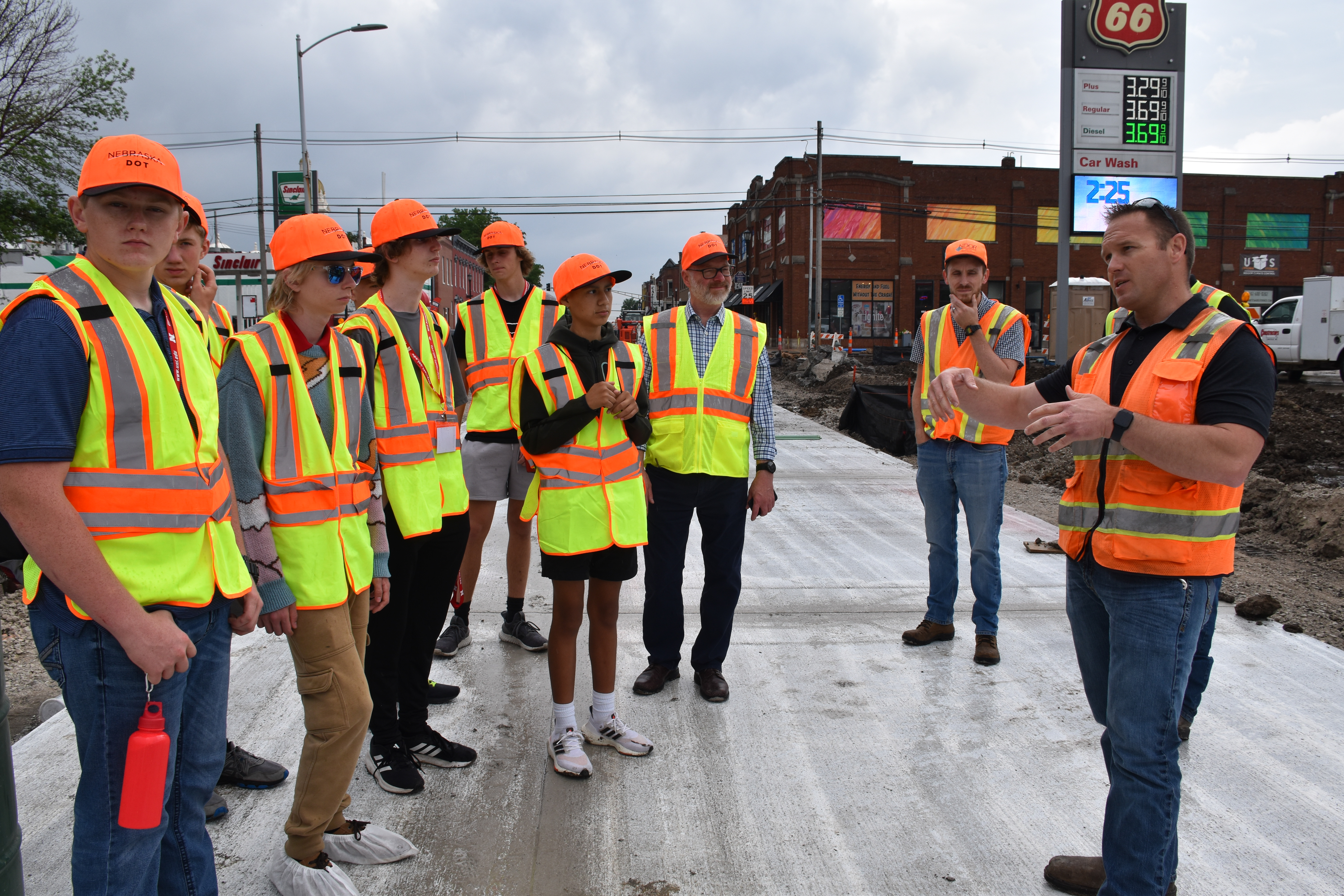 Students standing on a road during a tour of a construction site.