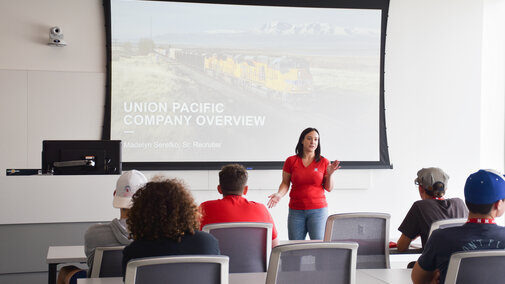 Union Pacific representative stand at the front of a classroom.