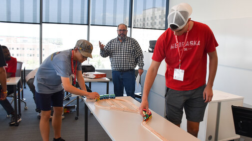 Students operating their own railroad using Brio wooden track.