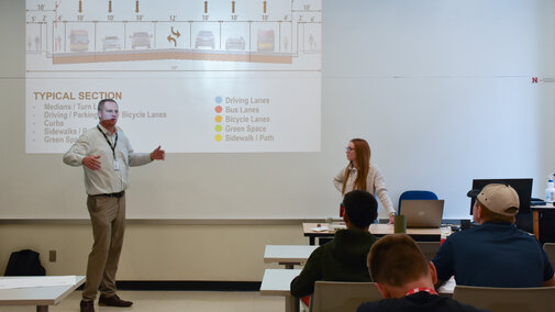 Engineers presenting to students.