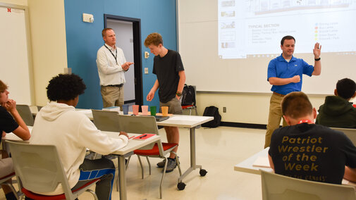 Students and engineers in a classroom.