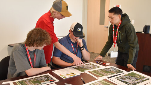 Students working at a table solving traffic flow problems at an elementary school.