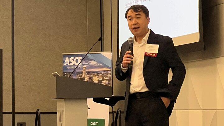 Dr. Nathan Huynh speaking at podium