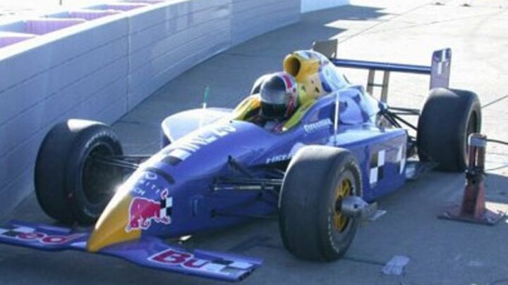 Formula 1 race car parked next to SAFER barrier