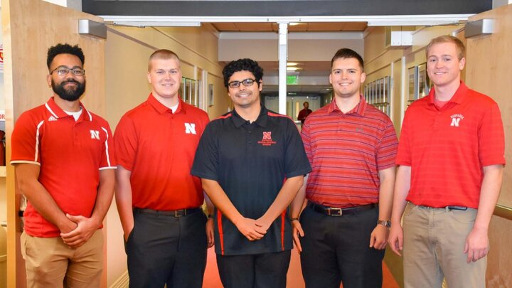 Five students in a group photo