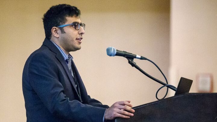 M. Ebrahim Mohammadi at podium speaking into a microphone