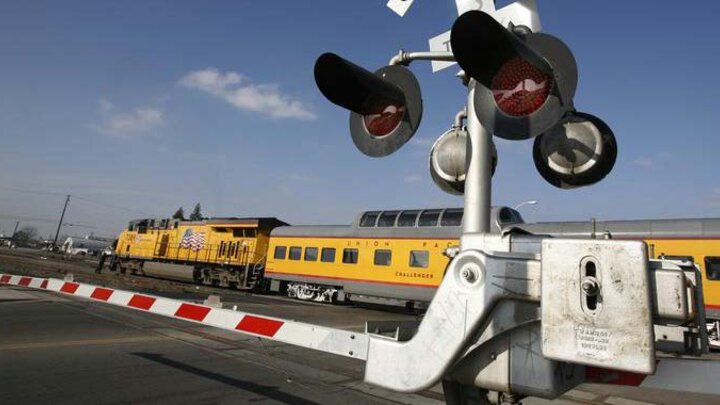 train and street intersection with train passing by