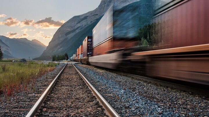 cargo train moving through mountians