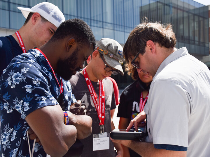 Dr. Richard Woods showing participants what the drone sees on a tablet.