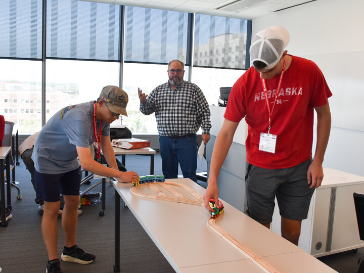 Students operating their own railroad using Brio wooden track.