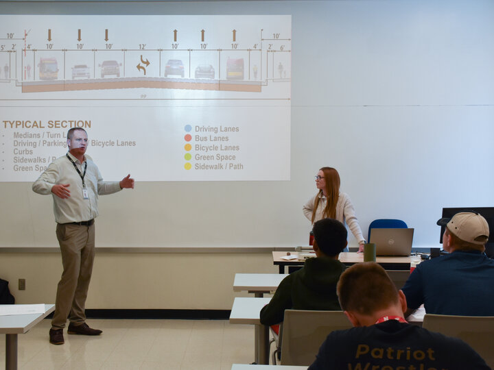 Engineers presenting to students.