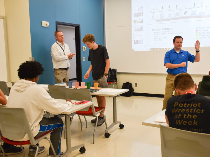 Students and engineers in a classroom.