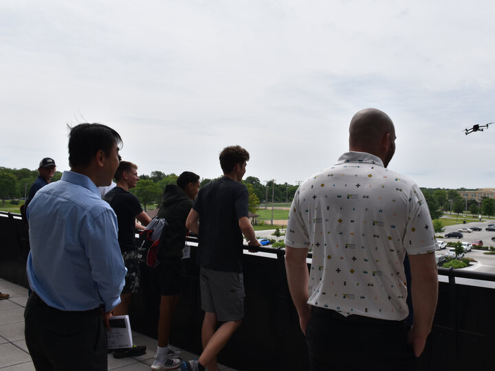 Program participants watch a demonstration of a drone.
