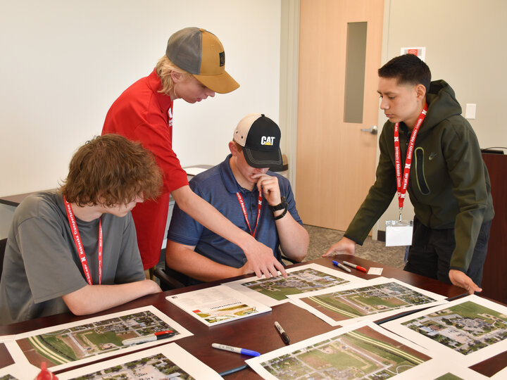 Students working at a table solving traffic flow problems at an elementary school.