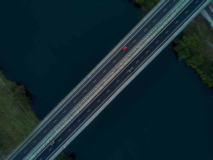 aerial shot of highway bridge over a river