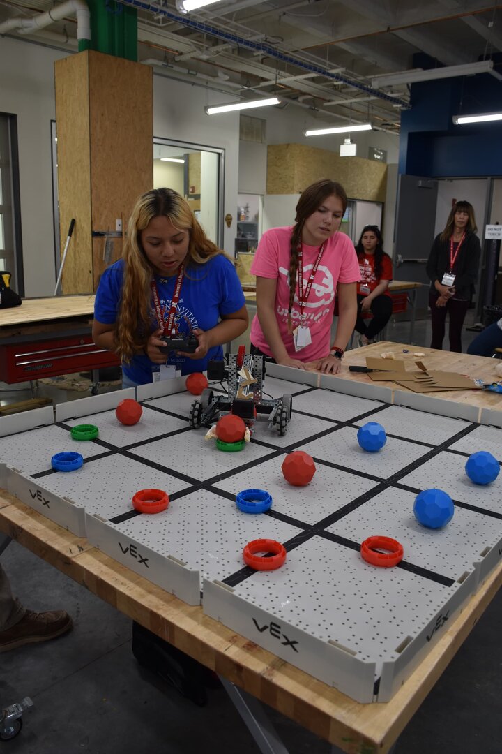 Two students testing their modified robot