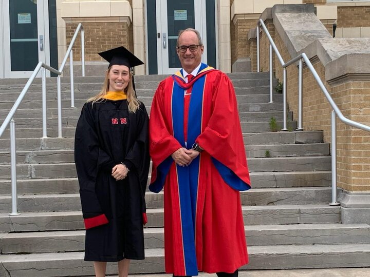 Sydney James and Dr. Laurence Rilett in graduation ceremony robes