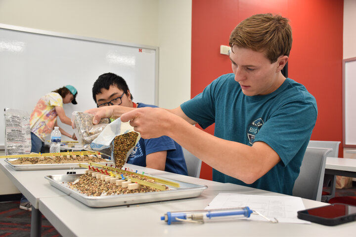 Participants working on a railroad track building activity.