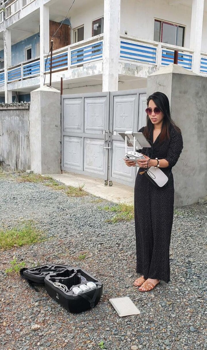 Huong using a drone outside